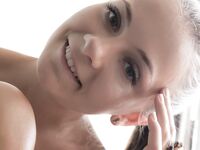 Divine teen hottie Ennu A shows off her perky boobies and that delicious shaved slit