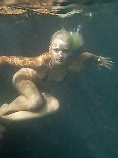Ukrainian beauty Nika N swims underwater for nude posing inside a cave